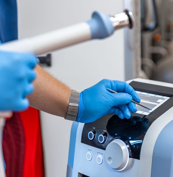 Shock wave therapy device with male doctor hands in rubber gloves, the magnetic field, rehabilitation.